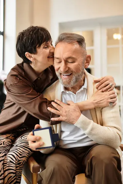 A middle aged couple shares a heartfelt moment at home, enjoying each other's company and laughter. — Stock Photo