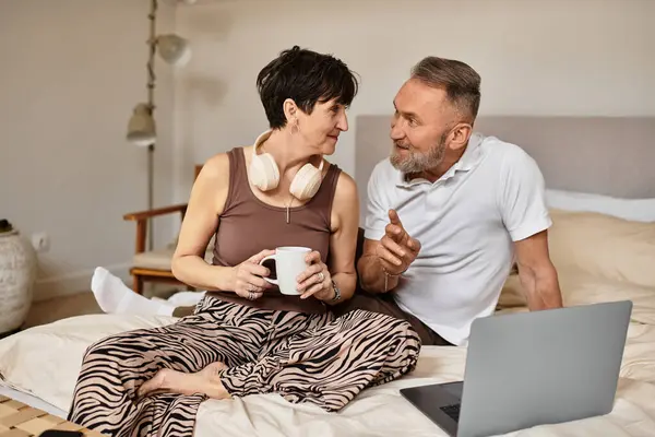 This happy couple shares laughter and warmth while relaxing in their peaceful bedroom. — Stock Photo