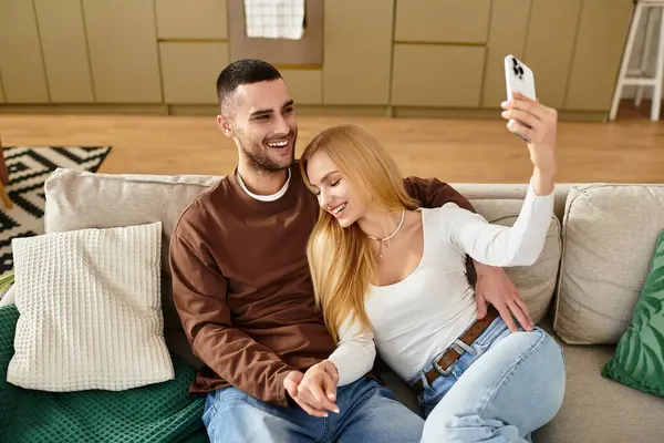 Loving pair enjoys quality time at home, capturing happy memories in a cozy living space. — Stock Photo