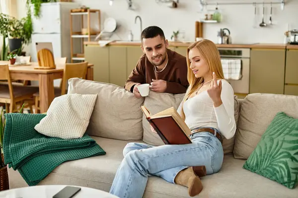 Couple shares a cozy afternoon full of reading and laughter in their comfy living room. — Stock Photo