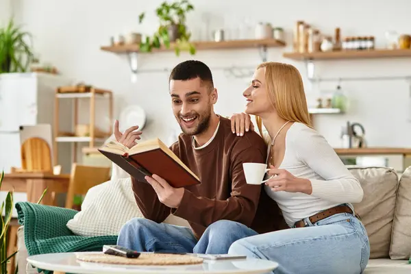 A couple laughs and enjoys reading a story in their cozy, inviting home. — Stock Photo