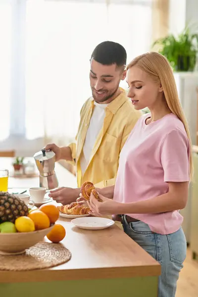 Sunlight fills the kitchen as the couple shares a joyful breakfast together. — Stock Photo