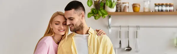 In a bright and inviting kitchen, a couple embraces, radiating affection and happiness. — Stock Photo