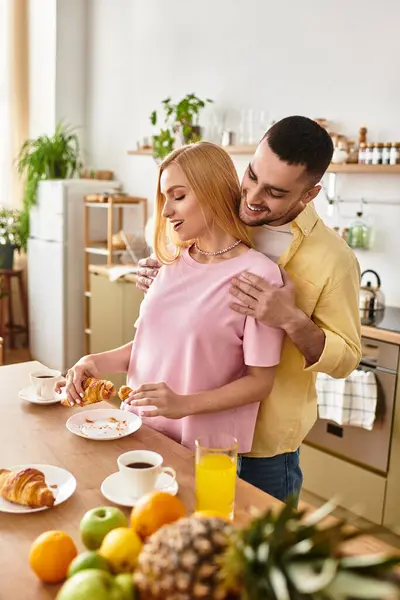 Sharing delightful moments, a couple connects over breakfast, savoring treats in their home. — Stock Photo