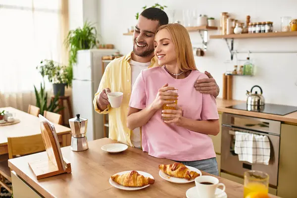 A couple shares a joyful breakfast moment, smiling and savoring each others company at home. — Stock Photo