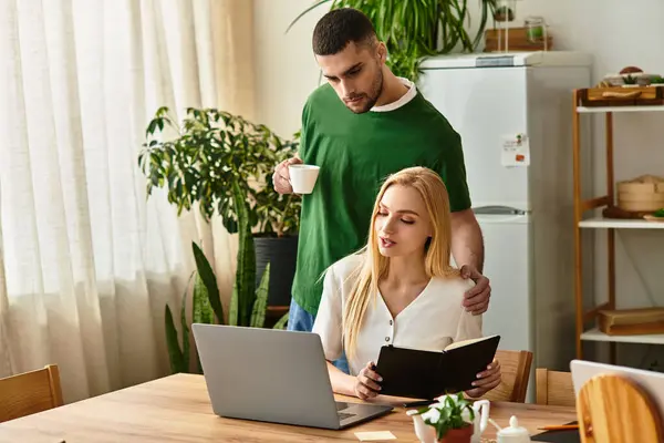 A couple enjoys a warm moment at home, with one reading and the other supporting them lovingly. — Stock Photo