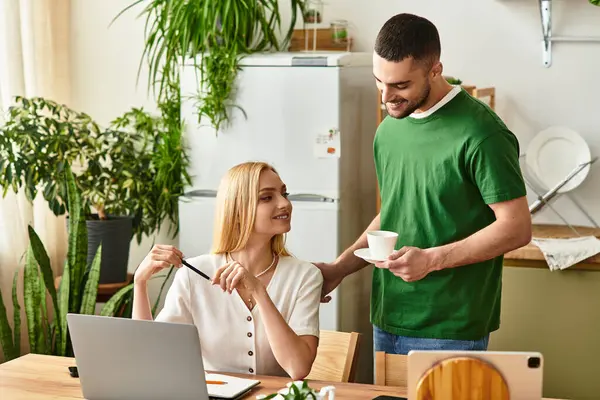 In a cozy kitchen, a couple laughs and connects over coffee as they share quiet moments at home. — Stock Photo