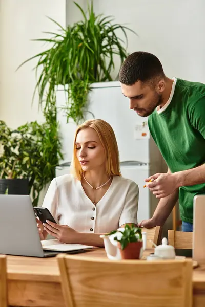Loving partners sharing a moment as they engage with their devices in a warm, inviting home. — Stock Photo