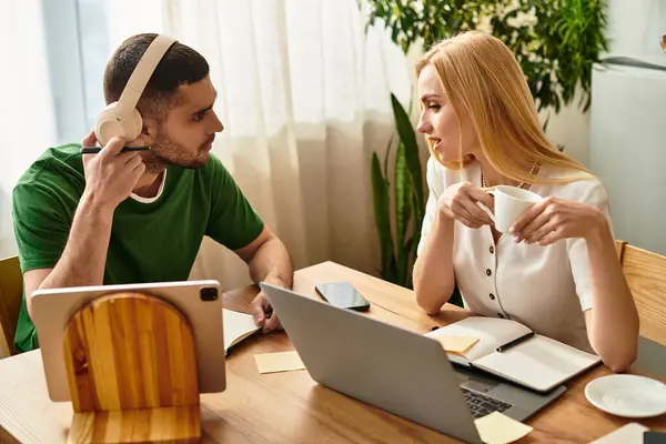 Loving couple engages in heartfelt conversation at their kitchen table, surrounded by warmth. — Stock Photo
