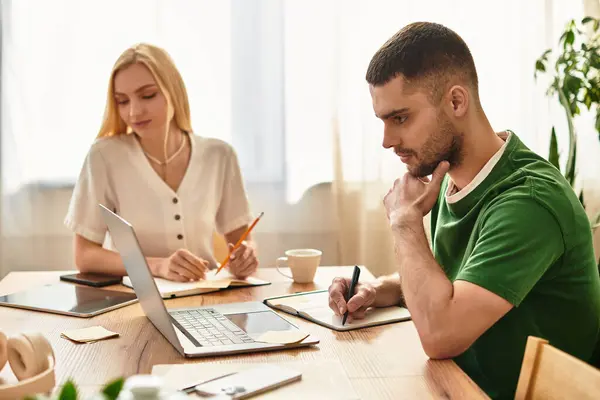 Warm sunlight fills the cozy space as a couple shares their day, engaging with work and love — Stock Photo
