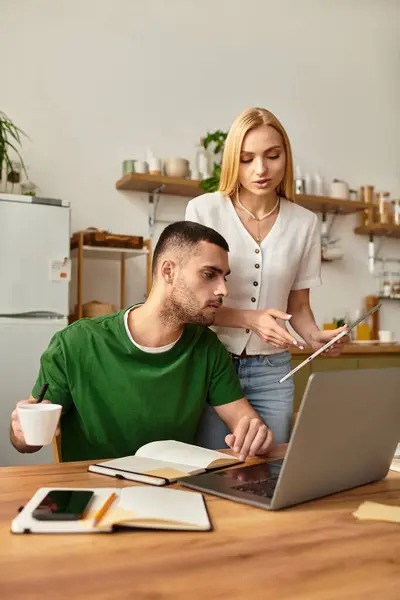 Couple engages in productive discussion at home, sharing ideas over coffee and technology. — Stock Photo