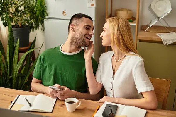 A couple shares an intimate moment in their cozy kitchen, smiling and enjoying each others company. — Stock Photo