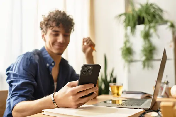 Handsome man enjoys his time using a smartphone during a productive work session at home — Stock Photo