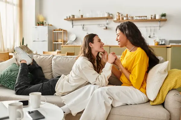 Two women share tender smiles and laughter, enjoying each others company in their home. — Stock Photo