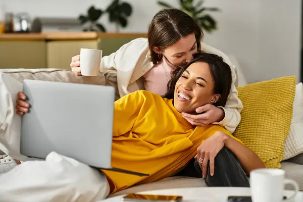 Two women share a warm moment at home while relaxing together and enjoying each others company. — Stock Photo