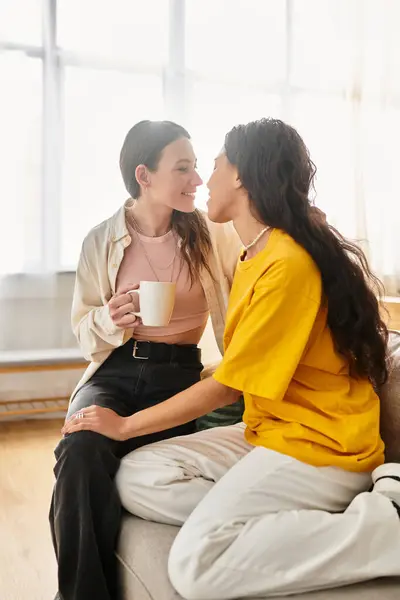 Two women share a warm, intimate moment at home, enjoying their deep connection. — Stock Photo