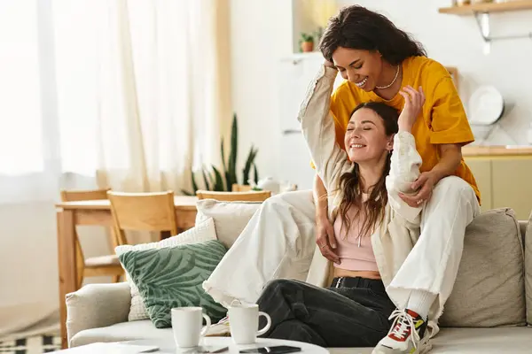 Zwei Frauen umarmen sich glücklich in ihrem hellen, warmen Wohnraum. — Stockfoto