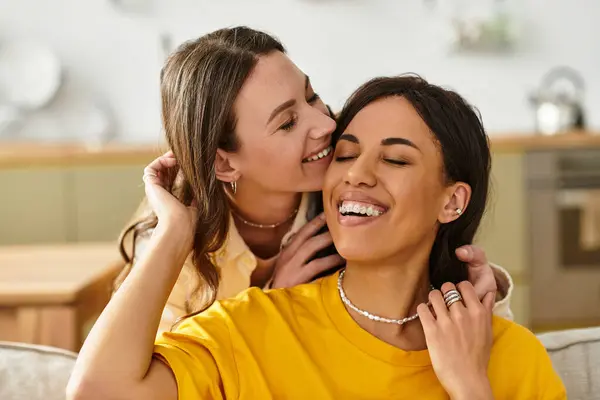 Two women share laughter and affection in their lovely home, embracing their love and joy. — Stock Photo