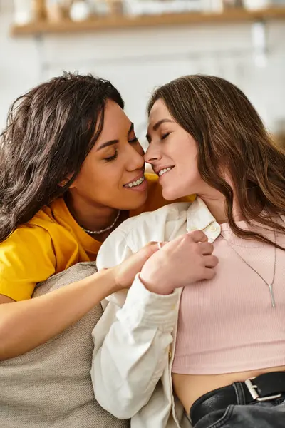 Two women share a tender embrace in their comfortable living space, filled with warmth and love. — Stock Photo