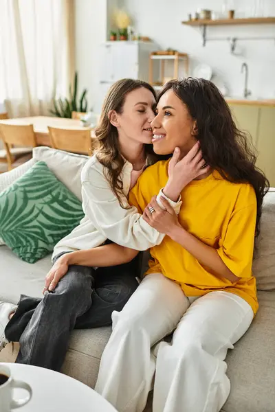 Women embrace each other affectionately while relaxing in their inviting living room atmosphere. — Stock Photo