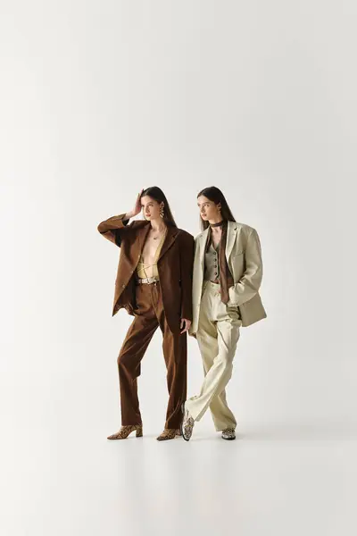 Twin sisters exude confidence and style in their coordinating suits, highlighting their bond. — Stock Photo