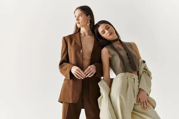 Twin sisters exude charm and fashion, creating a harmonious moment together in contemporary attire. — Stock Photo