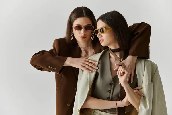 Fashionable twin sisters showcase their unique styles while enjoying each others company. — Stock Photo