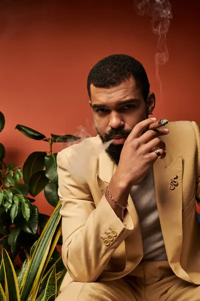 A stylish young man embraces summers charm while smoking and enjoying the day. — Stock Photo