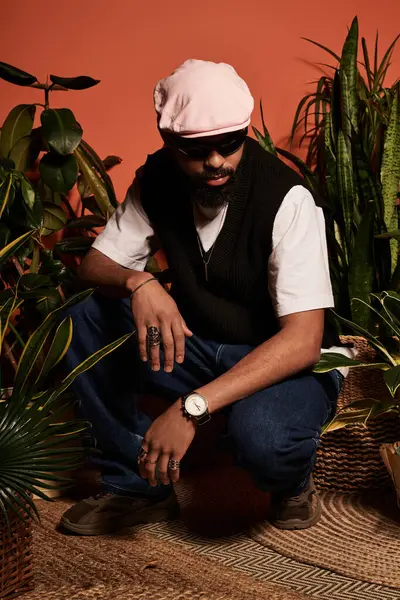 A young man showcases stylish summer attire among lush greenery, radiating confidence and charm. — Stock Photo