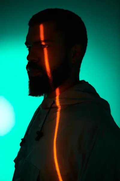 Un bell'uomo mette in mostra lo stile estivo con linee audaci di luce accentuando i suoi tratti. — Foto stock