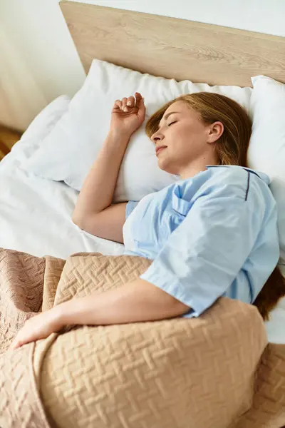 A beautiful woman rests serenely in bed, wrapped warmly in blankets, exuding tranquility at home. — Stock Photo