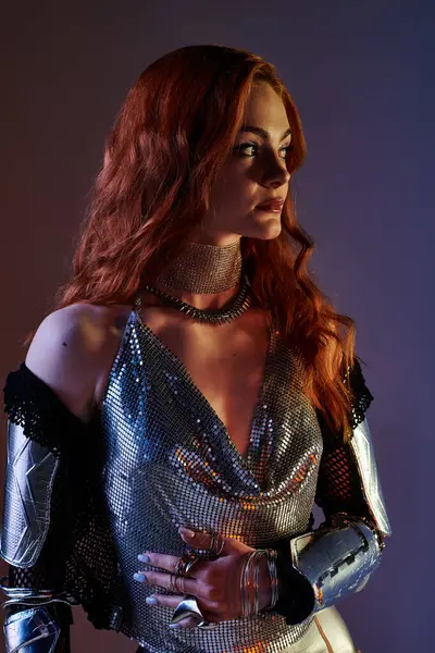 Young woman embodies elegance in remarkable armor inspired attire within enchanting lighting. — Stock Photo