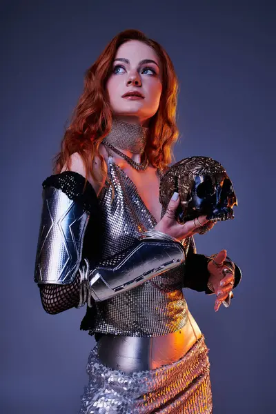 A stylish young woman holds a decorative skull, exuding elegance and creativity. — Stock Photo