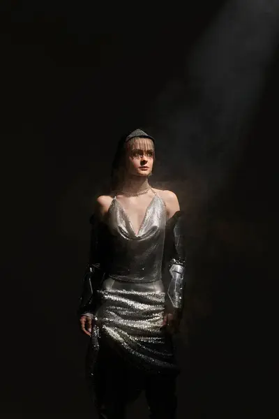A young woman stands confidently, showcasing her unique fashion sense in a captivating atmosphere. — Stock Photo