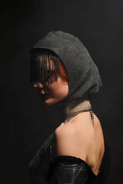 A young, beautiful woman embodies the essence of castle core fashion with a striking headpiece. — Stock Photo