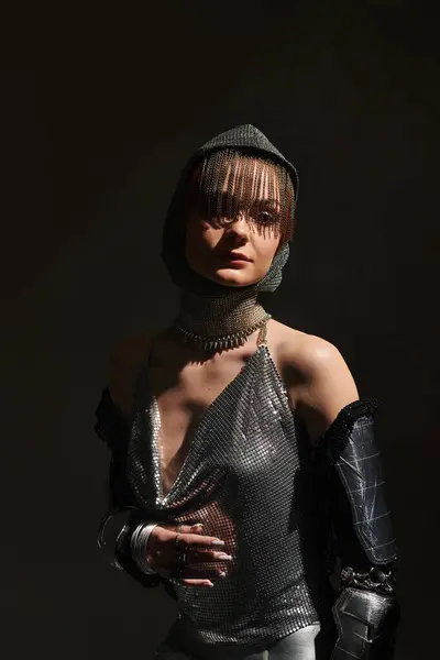 Stylish woman showcases a unique blend of elegance and knightcore fashion in a dramatic setting. — Stock Photo