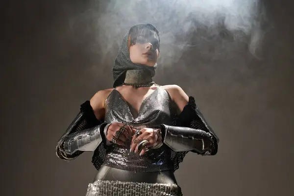 A young woman radiates elegance in a knightcore outfit amidst ethereal mist in a castle. — Stock Photo