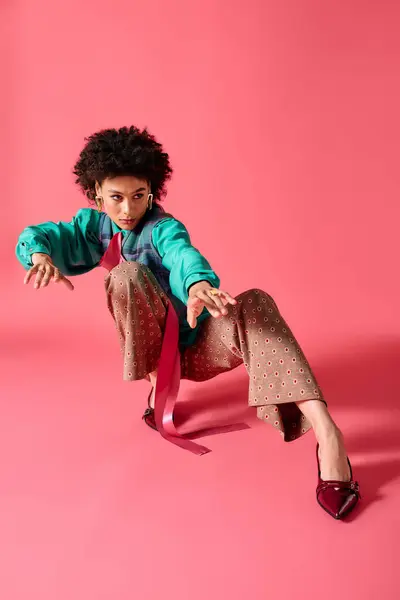 Stylish young woman demonstrates confidence with a dynamic pose while wearing colorful attire. — Stock Photo