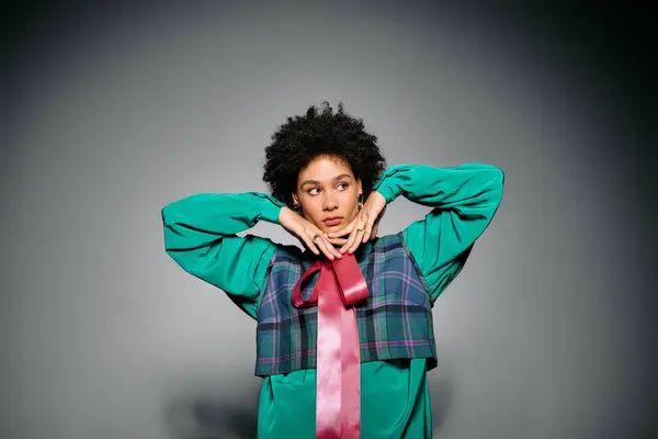 Stylish young woman poses elegantly with her hands near her face, exuding confidence and grace. — Stock Photo