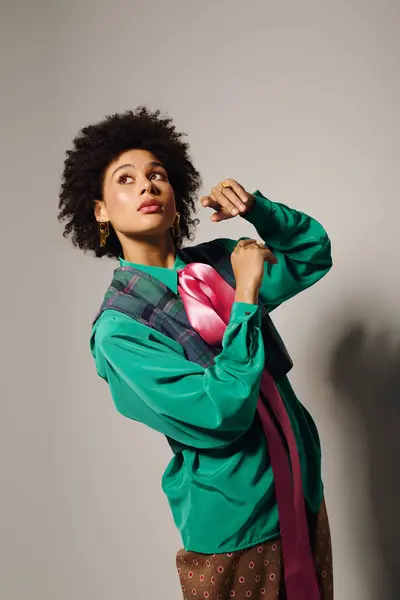 Chic young woman poses gracefully, showcasing stylish fashion in a modern studio setting. — Stock Photo