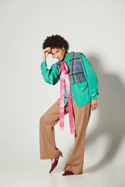 A stunning young woman poses confidently in a stylish outfit, showcasing her unique fashion sense. — Stock Photo