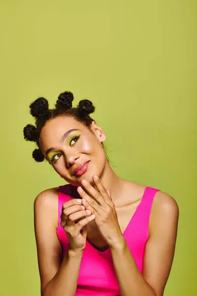 A young woman showcases her playful style with unique updos, bright makeup, and cheerful demeanor. — Stock Photo