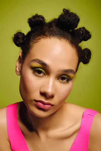 Mujer joven con estilo con peinado único y maquillaje audaz irradia confianza y creatividad. - foto de stock