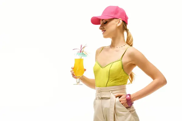 Brightly dressed woman enjoys a colorful tropical drink with a playful vibe in a lively atmosphere — Stock Photo