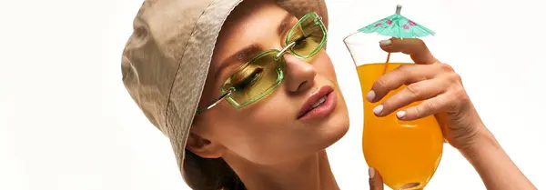 Bright colors and stylish accessories highlight a young womans relaxed summer vibe with a drink. — Stock Photo