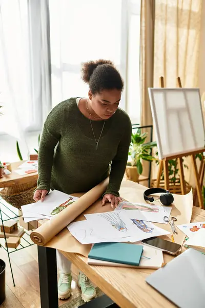 A beautiful woman engages in crafting activities at a well lit workshop, surrounded by materials. — Stock Photo