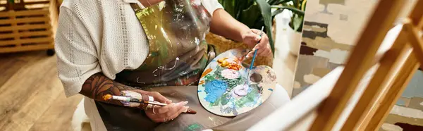A skilled artisan passionately engages in crafting, surrounded by colorful materials in a workshop. — Stock Photo