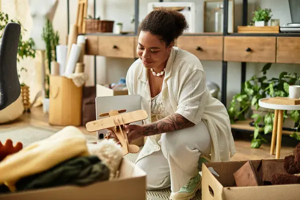 A beautiful woman focuses on her latest art project in a well organized crafting workshop. — Stock Photo