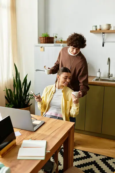 Couple enjoys drinks and joyful moments in their cozy kitchen. — Stock Photo