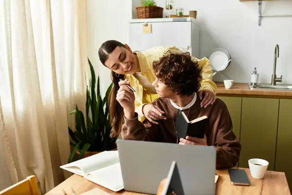 In a warm kitchen setting, a couple shares joy and affection while reading and studying together. — Stock Photo